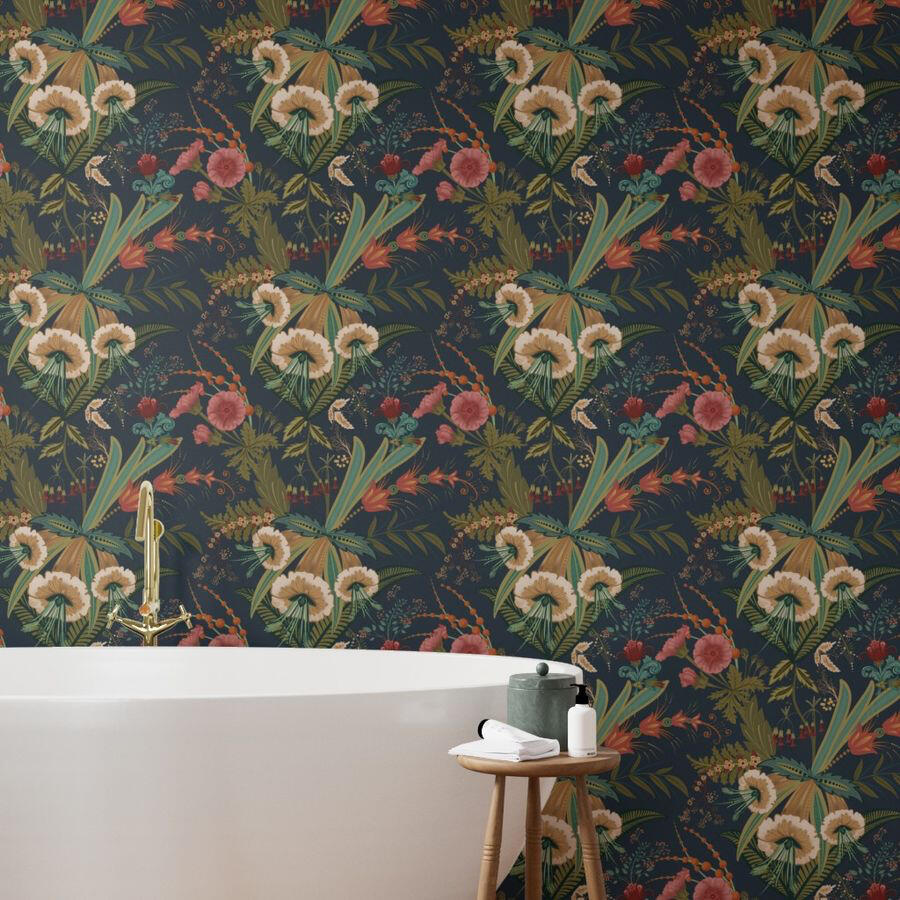 Untitled Freestanding white bathtub against a wall covered in dark botanical wallpaper with cream flowers, coral blooms, and lush green foliage.